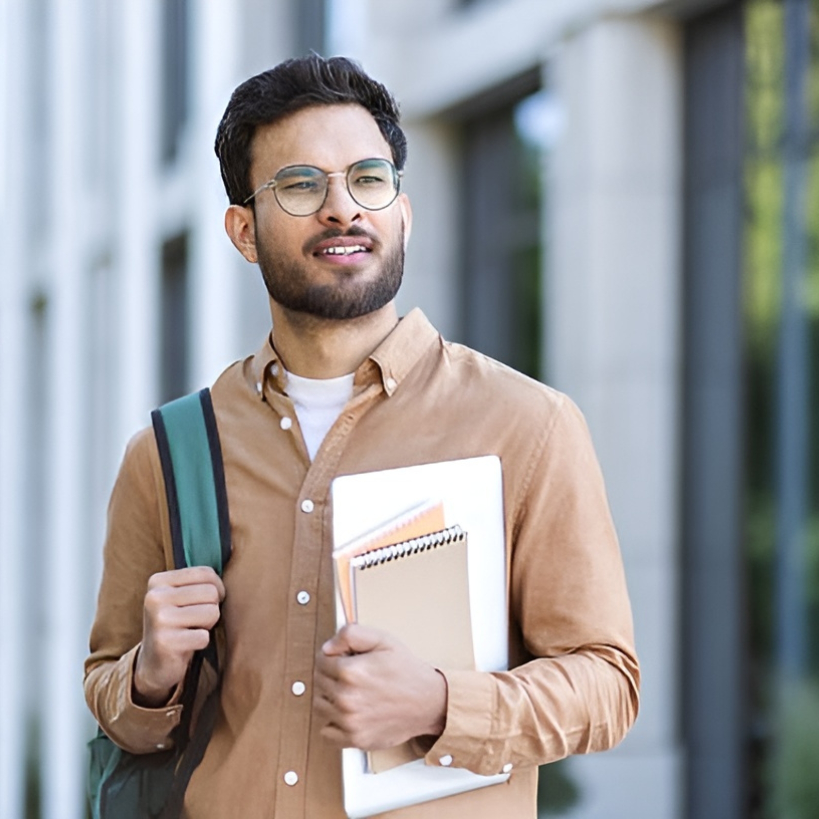 Smiling graduate student holding documents